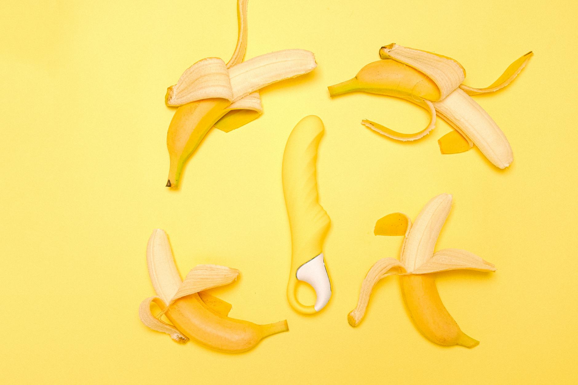 A yellow silicone clitoral vibrator displayed on a bright background, representing fresh starts in intimacy