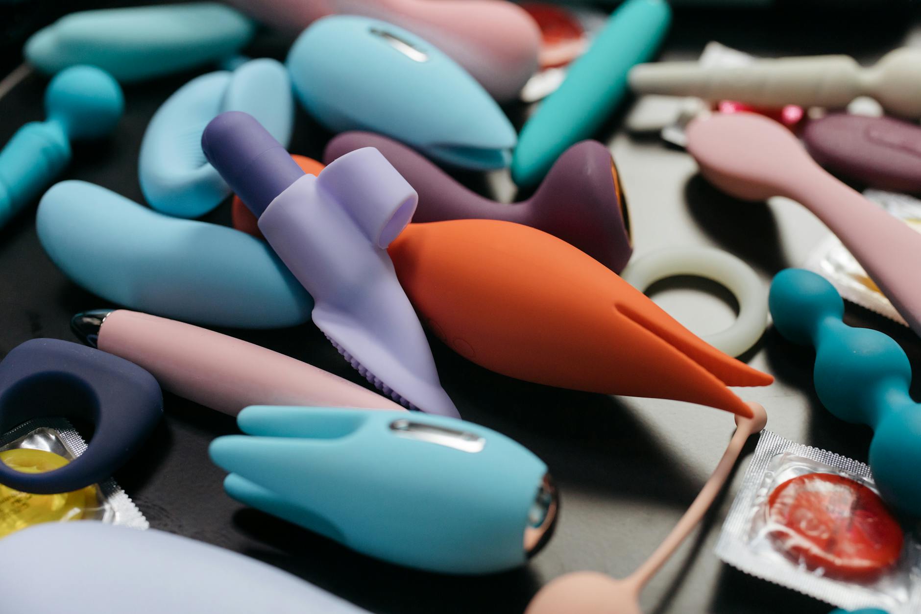 A young couple holding a vibrator together, symbolizing modern intimacy and rebuilding connection