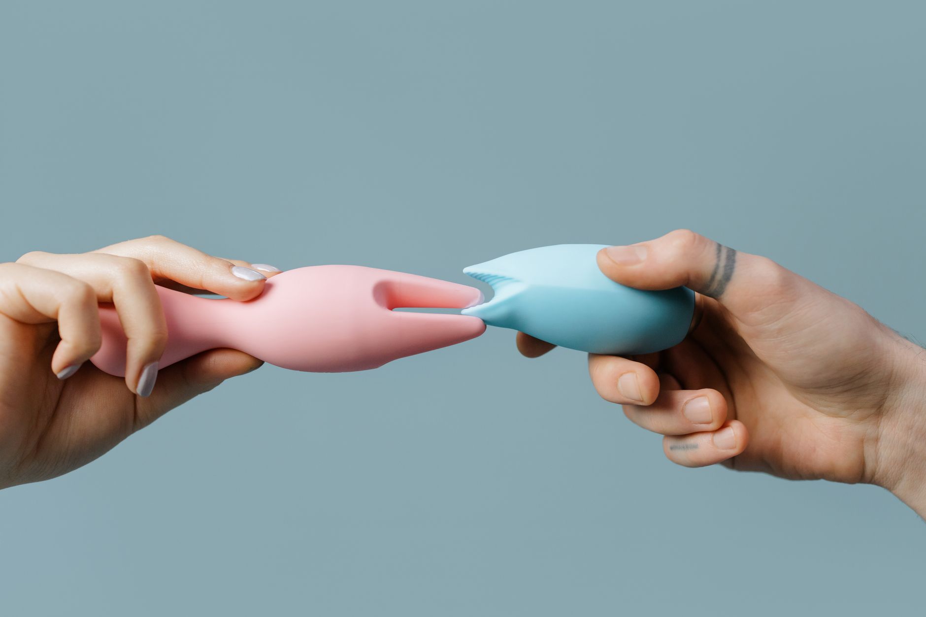 Hand holding a colorful silicone toy, demonstrating intimate personal choice.