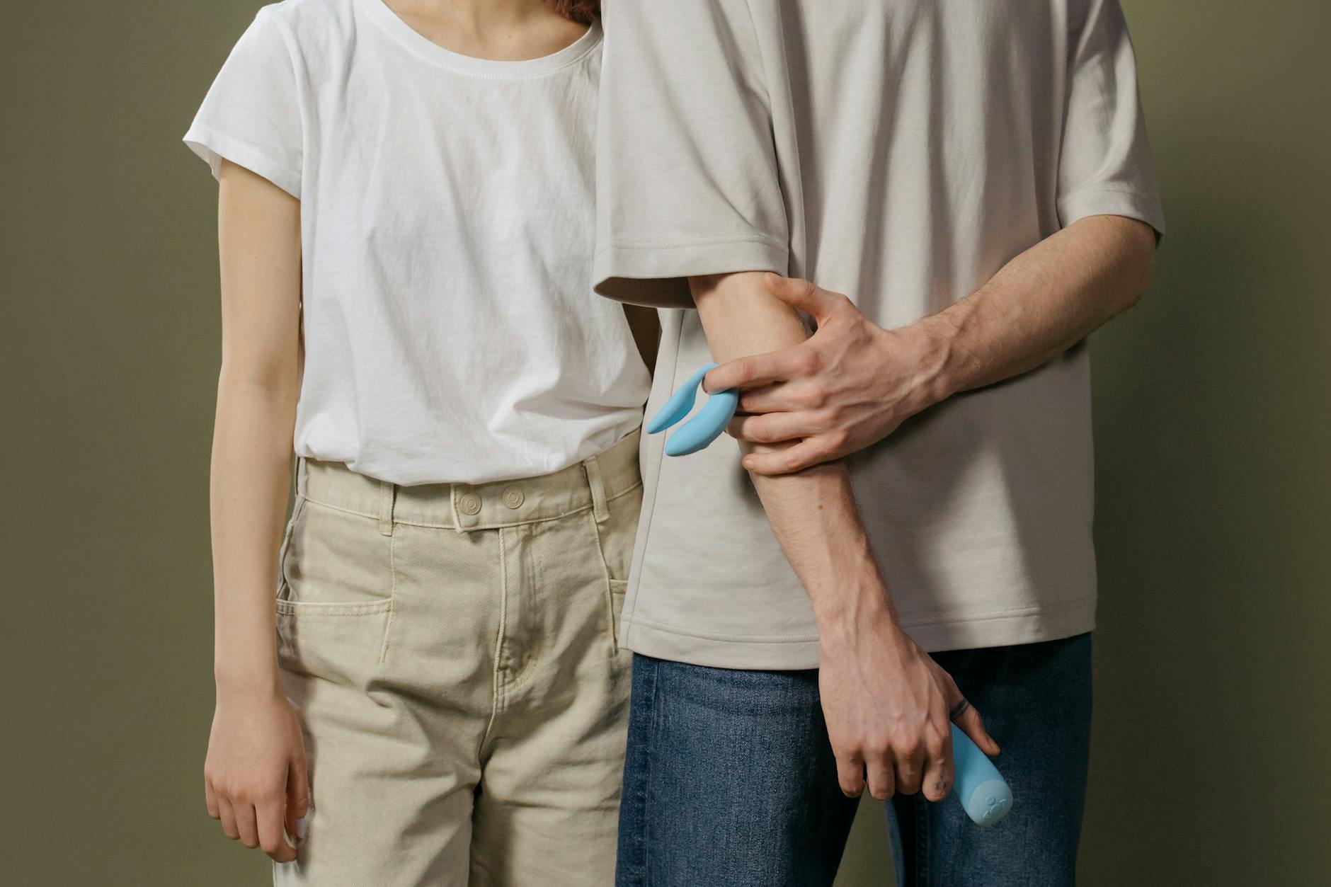 A couple standing together indoors, exploring modern intimacy and connection with curiosity and openness