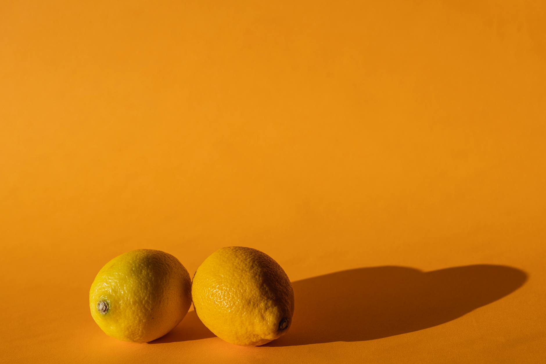Yellow lemons on a pastel green background